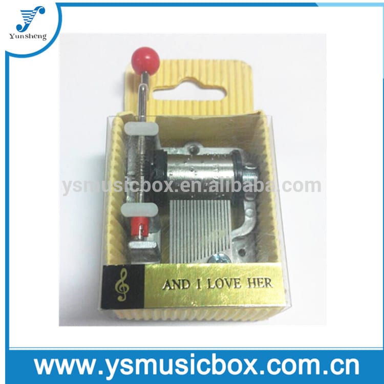 Hand crank music box ine yellow paper box