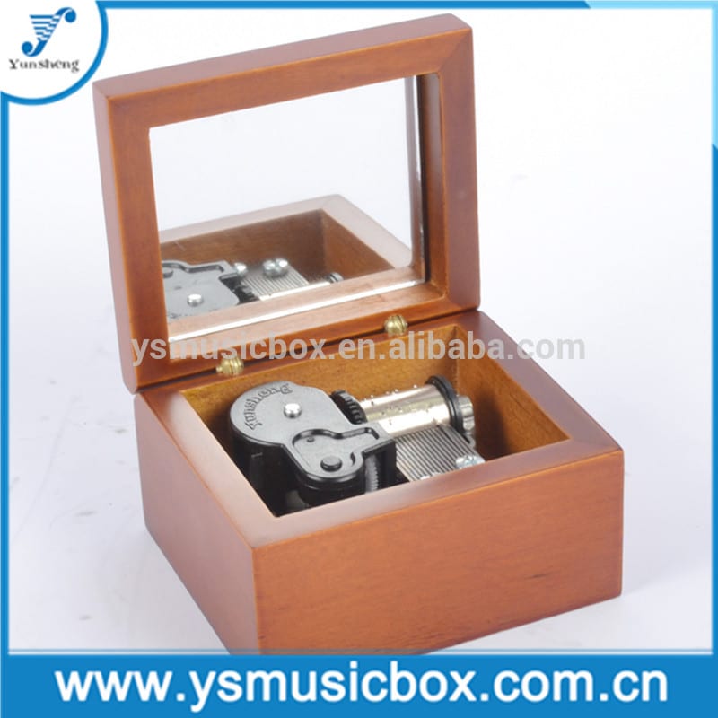 brown wooden music box with golden musical movement